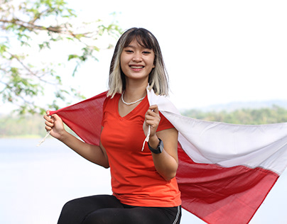 Asian young woman carrying the Indonesian flag