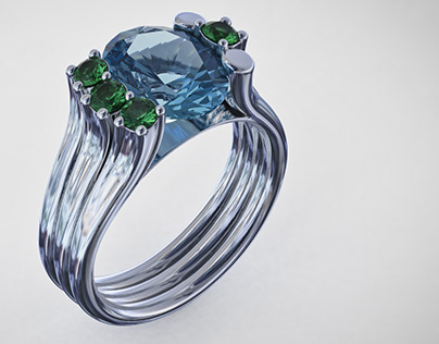 White gold ring with sapphire and emeralds