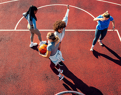 Group of young woman having fun playing basketball.