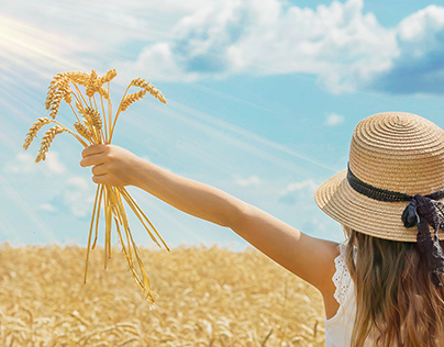 summer background with child ears of wheat.