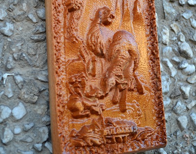 Carving of two sheep and little lamb