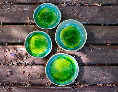 Green ceramic saucers glazed with colored glass