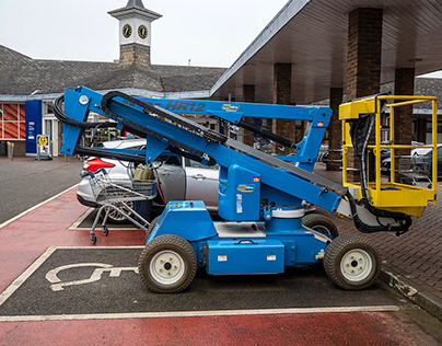 Cherry picker in disabled parking bay