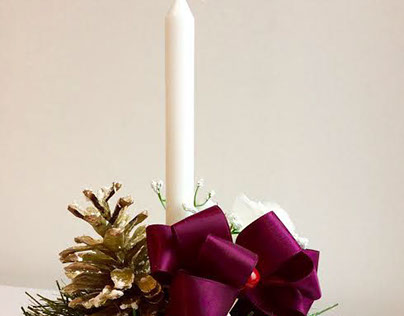 Christmas decoration with a purple bow & white candle£7