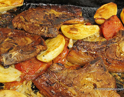 Oven baked pork chops with potatoes and tomatoes