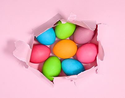 Colorful Easter eggs in hole of torn paper. Stop motion