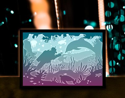 Diver paper cut night light template on the ocean floor