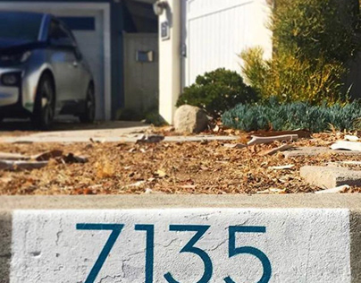 house number painted on curb