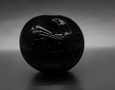 Black plum berry in water drops