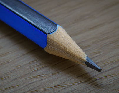 a pencil on a wooden textured background