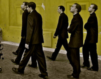 A group of priests approach the gates of the Vatican.